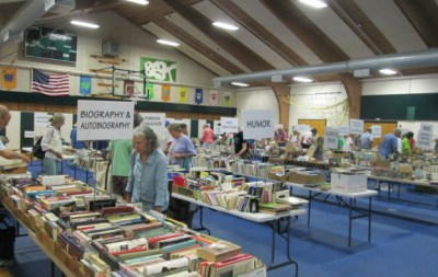 The book sale takes place in the elementary school gym. All the sorting and shelving is done by volunteers.